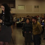 Fans look on as Molly Crabapple works on her piece Fans look on as Molly Crabapple works on her piece