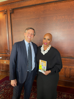 CBLDF Interim Director Jeff Trexler and Congresswoman Ayanna Pressley, holding a copy of Gender Queer at the Congressional Roundtable on Book Bans, in the Library of Congress